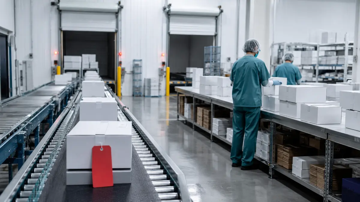 Personal sanitario prepara cajas de dispositivos en una línea logística con un envío retenido